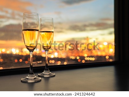Glasses of white wine against sunset
