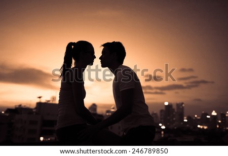 Romantic young couple kissing in the city