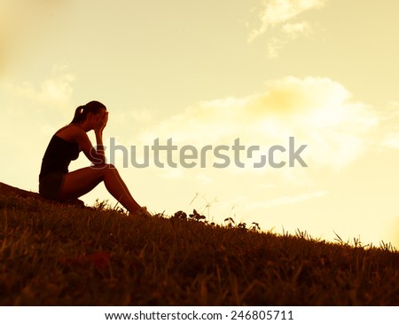 Sad and depressed woman deep in thoughts outdoors