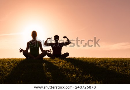 Couple meditating outdoors