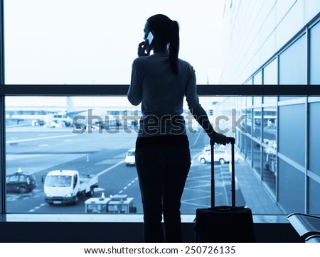 Woman talking on the phone in the airport terminal