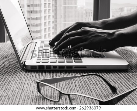Closeup of hands typing in a office setting
