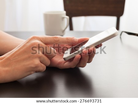 Woman using her phone in a meeting.