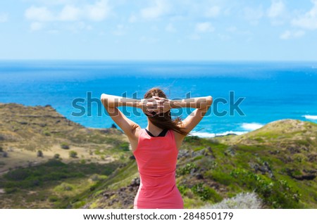 Female hiker enjoying the beautiful view. (Location Hawaii)