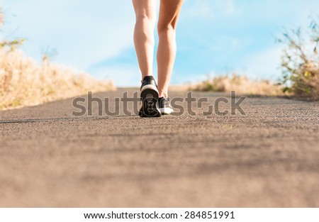 Woman walking on a path. (Fitness concept)