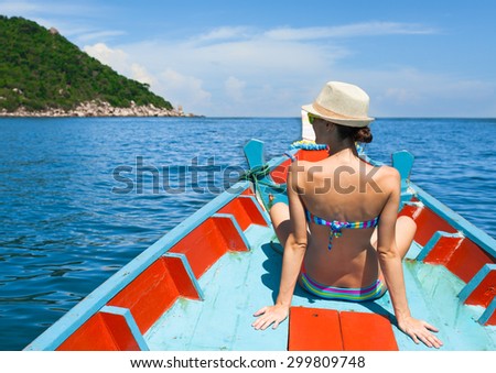 Woman taking a exotic boat ride. (location Thailand)