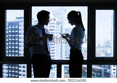 Professionals having a discussion in a office setting.