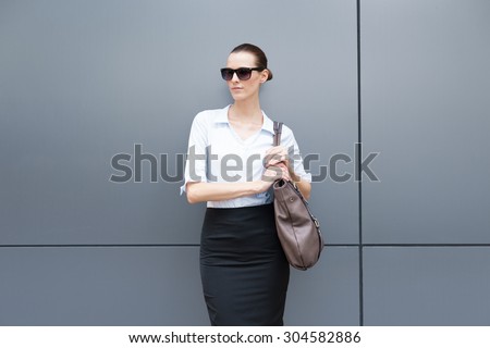 Fashion portrait of woman holding purse.