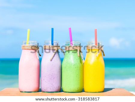 Fresh fruits smoothies on the beach