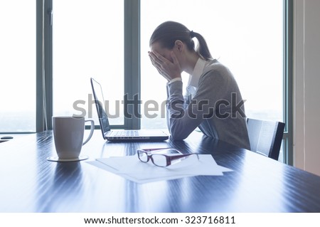 Woman feeling stress from work.