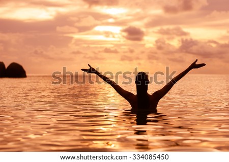 Female enjoying the beautiful sunset. (Positive life concepts)