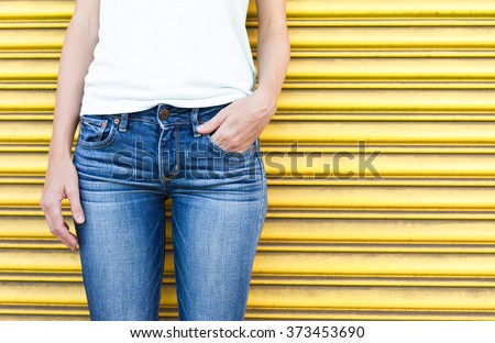 Closeup of female wearing jeans.