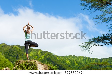 Woman practicing yoga in the mountains of Hawaii.