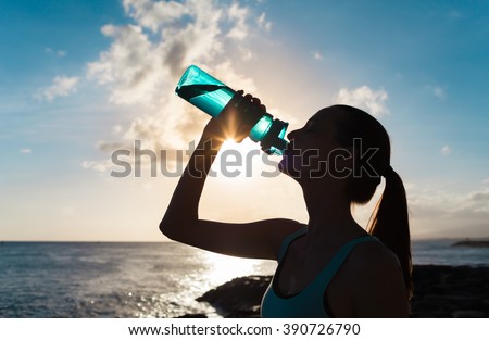 Female drinking water on a hot day.