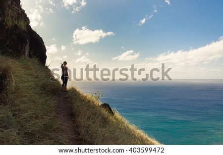 Young woman looking out at the beautiful ocean view.