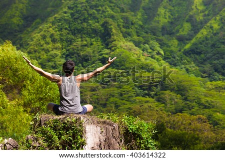 Young man feeling free in nature. Peace and relaxation concept.