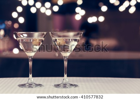 Martini glasses on a bar.