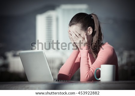 Stressed out businesswoman on her computer.