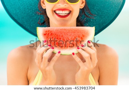 Fun beach summer holiday concept.  Woman holding watermelon on the beach.