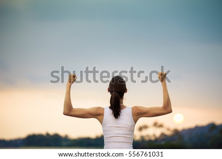 Woman power! Strong and confident woman flexing her muscles.