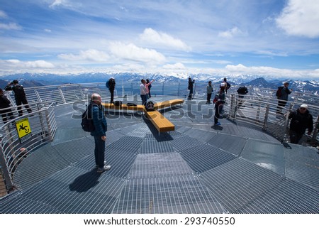 People enjoying and making pictures on panorama terrace 360 degree overview to Italian Alps and Mont Blanc - Punta Helbronner station, Monte Bianco, Italy, June 22, 2015