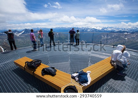 People enjoying and making pictures on panorama terrace 360 degree overview to Italian Alps and Mont Blanc - Punta Helbronner station, Monte Bianco, Italy, June 22, 2015