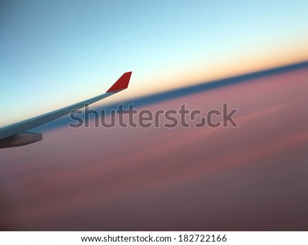 plane flying over the earth, wing, sunset in the sky, the night comes