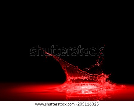 High resolution, splash of red wine on black background