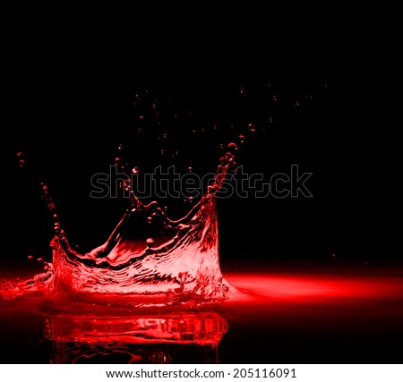 High resolution, splash of red wine on black background