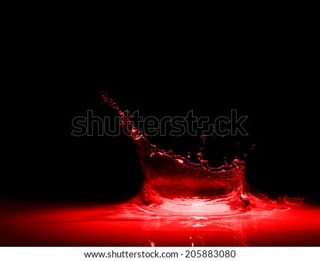 splash of red wine on a black background