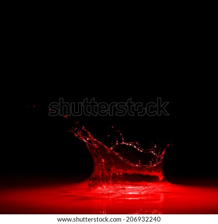 splash of red wine on black background