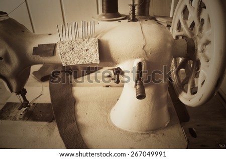 hand wheel old sewing machine. horizontal format, sepia, monochrome
