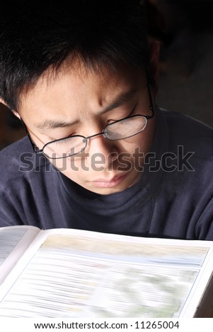 Young boy studying hard