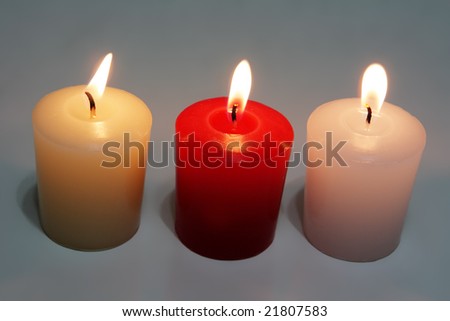 Three fragrance candles in red, white, and yellow
