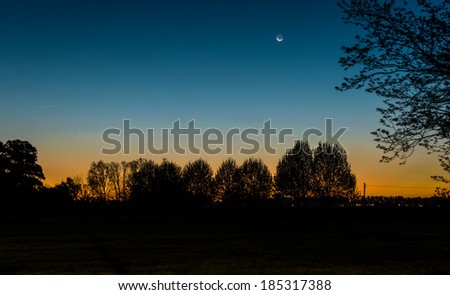 Vibrant Sunset with moonlight at local Argentine countryside Farm.