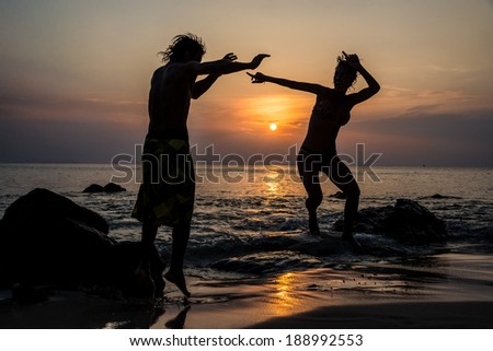 Happy Couple in Love Jumping, Fun. Tropical Island Sunset. Thailand. Asia adventure.