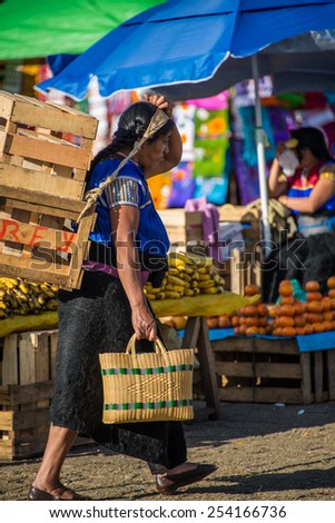SAN JUAN CHAMULA, MEXICO - DECEMBER 2 San Juan Chamula, inhabited by indigenous Tzotzil Maya people, traditional market, selling fruits and hand crafts on December 2, 2014 in San Juan Chamula, Mexico