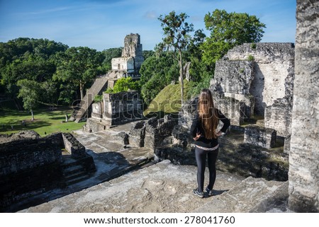 Woman looking at Mayan historic building at Tikal Jungle. Guatemala.