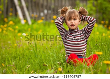 Funny lovely little five-year girl in park