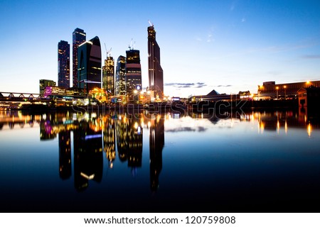 Skyscrapers Moscow business centre (Moscow City) at evening with water reflections.
