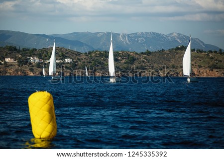 Sailing boats participate in sail yacht regatta in Aegean Sea, Greece Adventure and luxury holiday.