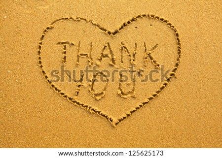 Texture of sand, the inscription inside the heart of Thank You.