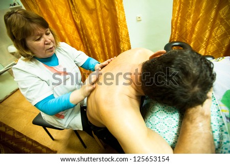 PODPOROZHYE, RUSSIA - OCT 11: Massage for young disabled people in program Day of Health in Center of social services for pensioners and the disabled Otrada, October 11, 2012 in Podporozhye, Russia.