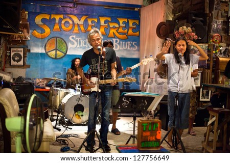 KO CHANG/TRAT, THAILAND - FEBRUARY 10: Classic rock cover band  Stone Free performing in a night club Sticky Rice Blues, February 10, 2013 on Ko Chang island, Thailand.