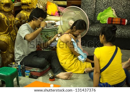 NAKHON CHAI, THAILAND - MAR 1: Unidentified master makes traditional Yantra tattooing on Mar 1, 2012 in Nakhon Chai, Thailand. Yantra tattoo also called Sak Yant practiced in Southeast Asian countries