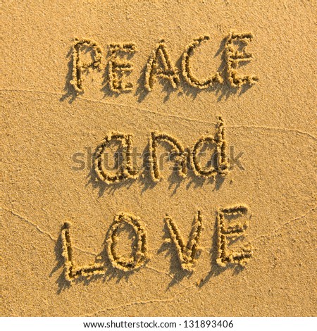 Peace and Love - drawn on the sand of a beach