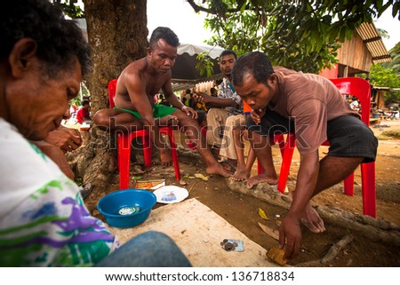 BERDUT, MALAYSIA - APR 8: Unidentified people Orang Asli during play cards on Apr 8, 2013 in Berdut, Malaysia. More 76% of all Orang Asli live below the poverty line, life expectancy - 53 years old.