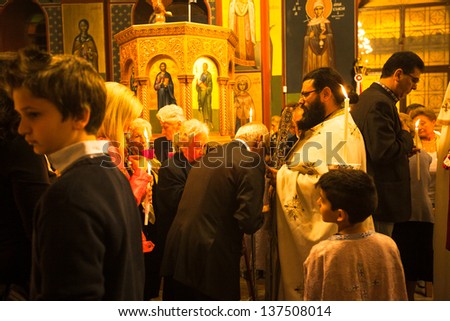 METHANA, GREECE - MAY 5: Unidentified people in the church during the celebration of Orthodox Easter, May 5, 2013 in Methana, Greece.