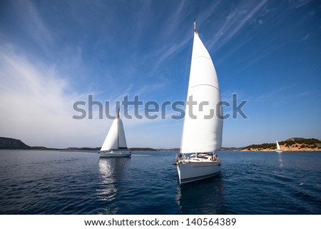 Sailing ship yachts with white sails in a row Sailing ship yachts with white sails in a row