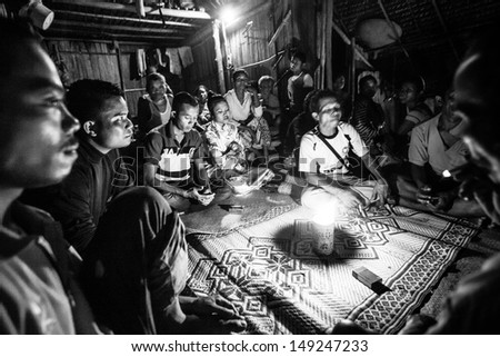 BERDUT, MALAYSIA - APR 8: Unidentified people Orang Asli during a ceremonial dinner  (b/w photo) on Apr 8, 2013 in Berdut, Malaysia. More than 76% of all Orang Asli live below the poverty line.